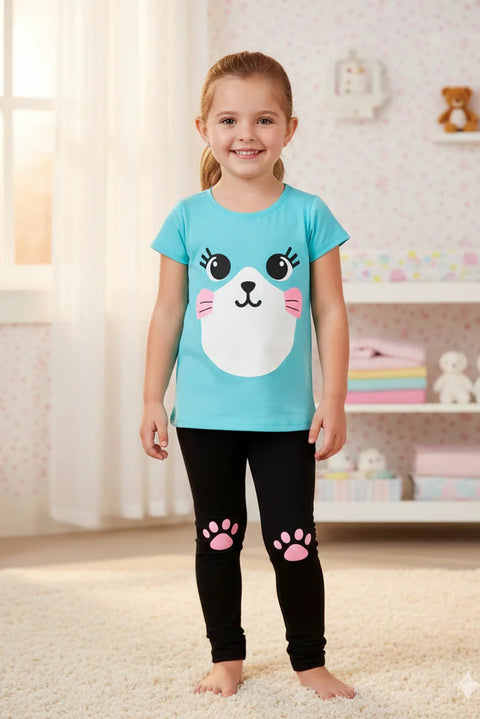 Child wearing a blue t-shirt with a cat face design and black leggings with pink paw prints in a room.