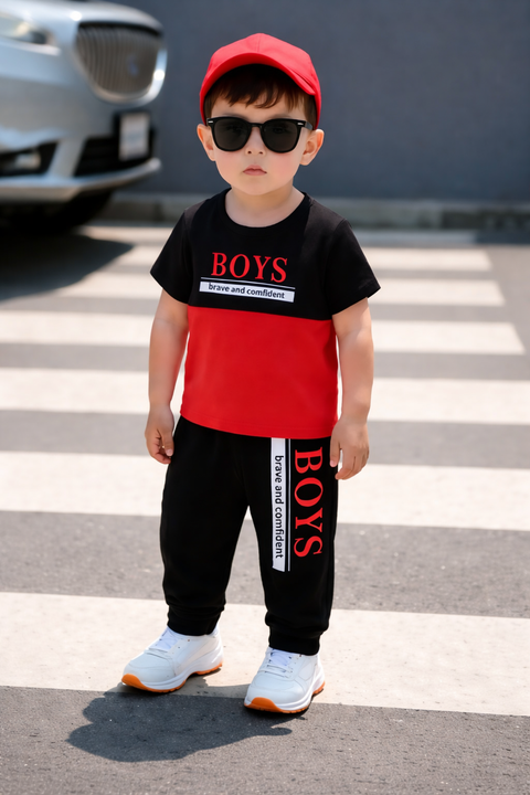 Child wearing a black and red outfit with 'BOYS' text on a crosswalk.