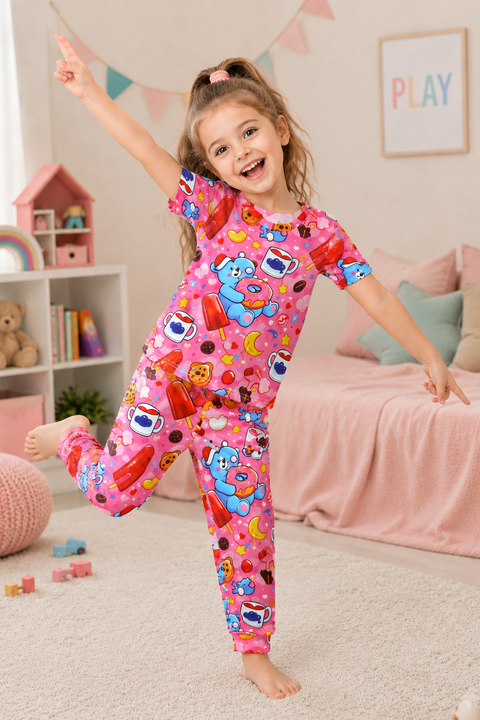Child wearing a colorful pajama set in a bedroom