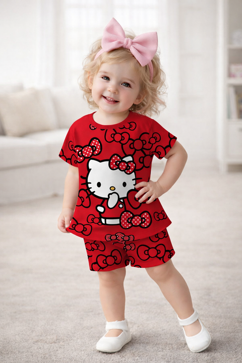 Child wearing a red outfit with a cartoon character, standing indoors.