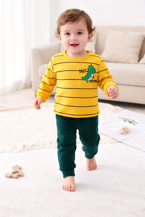 Child wearing a yellow and green outfit with a dinosaur design, standing on a light-colored carpet.