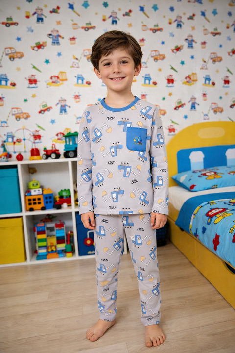 Child wearing pajamas with vehicle pattern in a room with colorful toys and furniture.